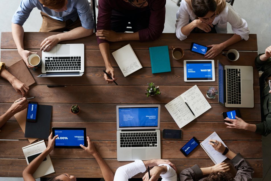 Hände, Notebooks und Lernmaterial auf einem Tisch